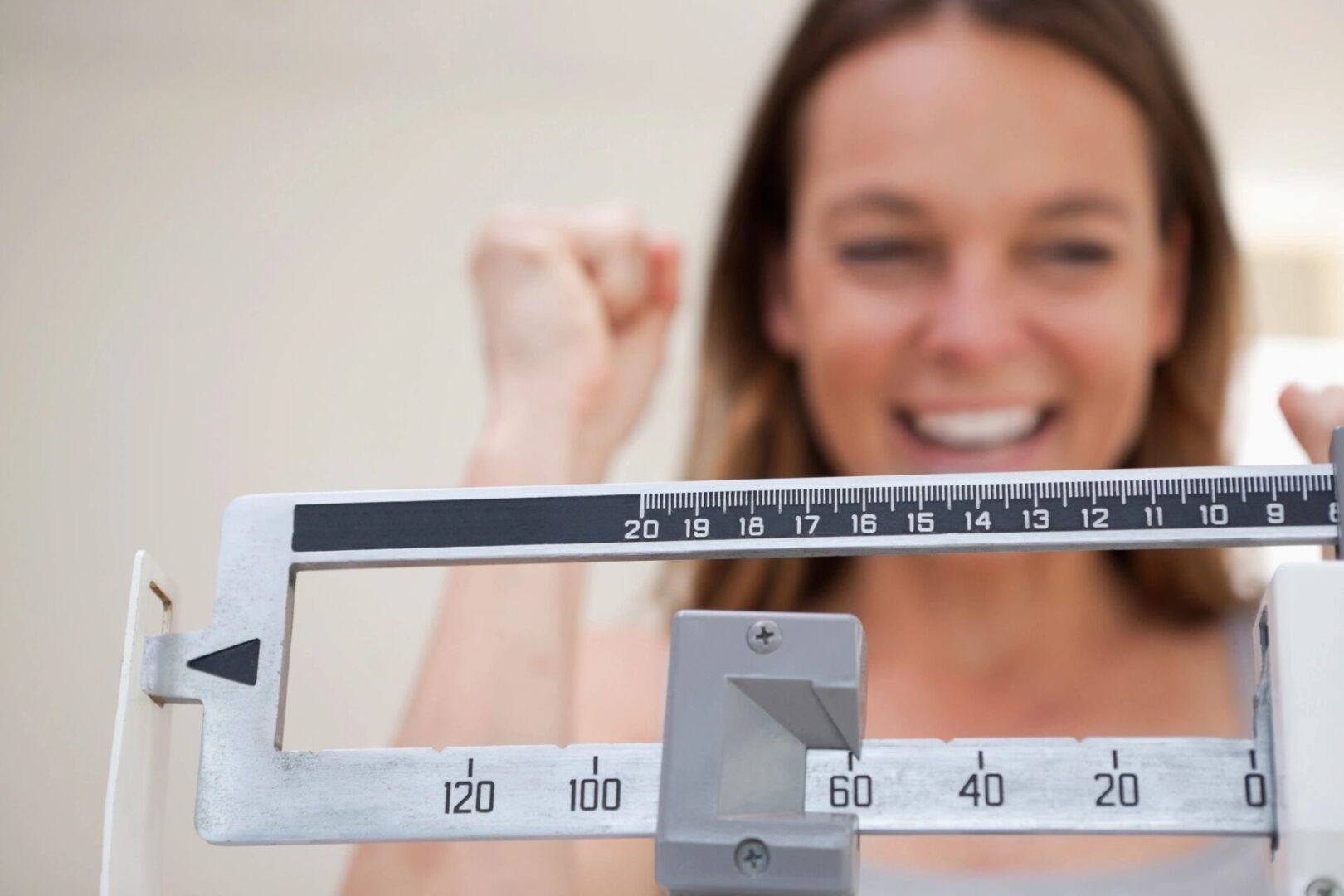 Happy woman checking her weight